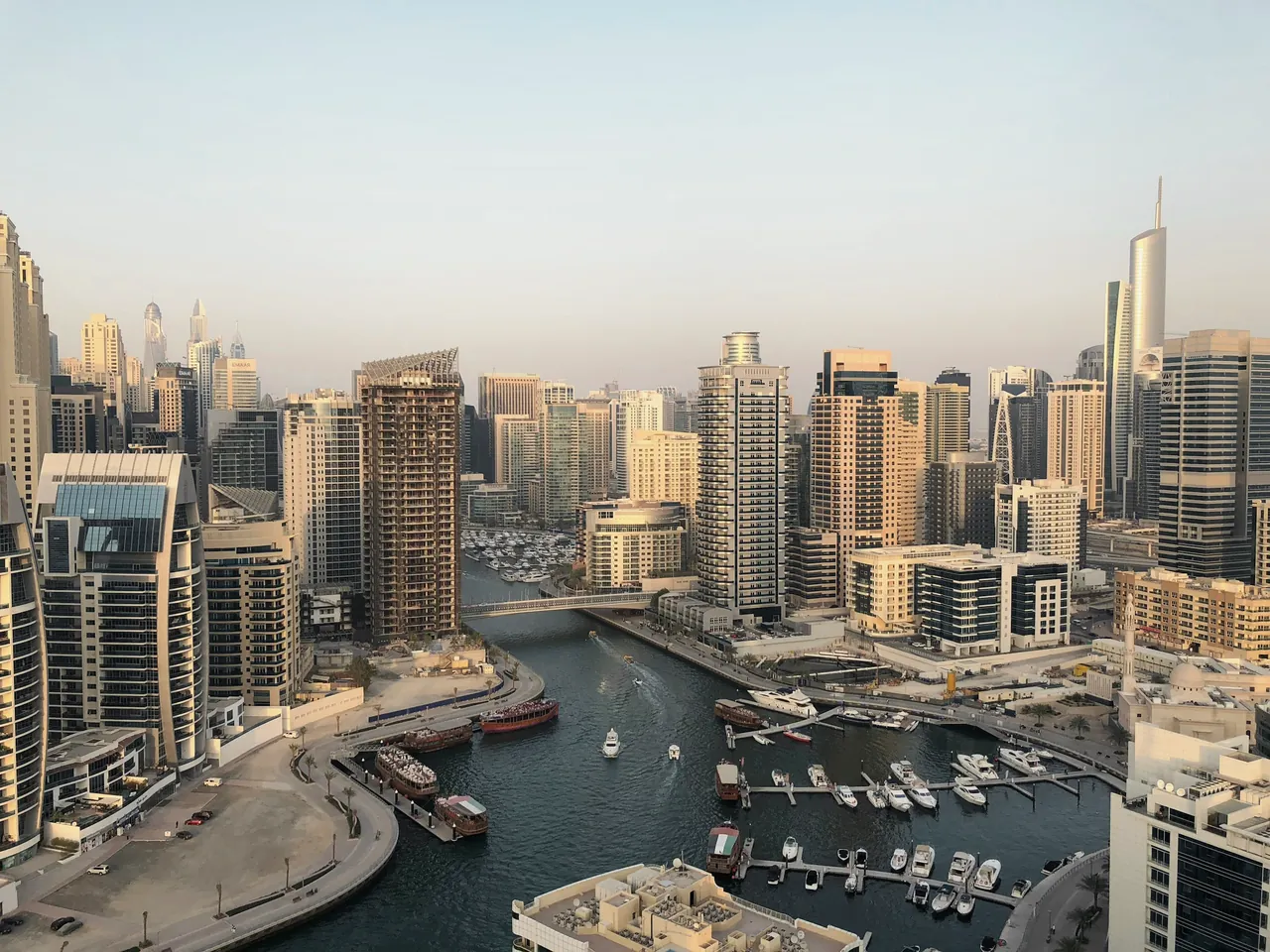 Dubai Marina's canal and towers seen from a high floor in late light